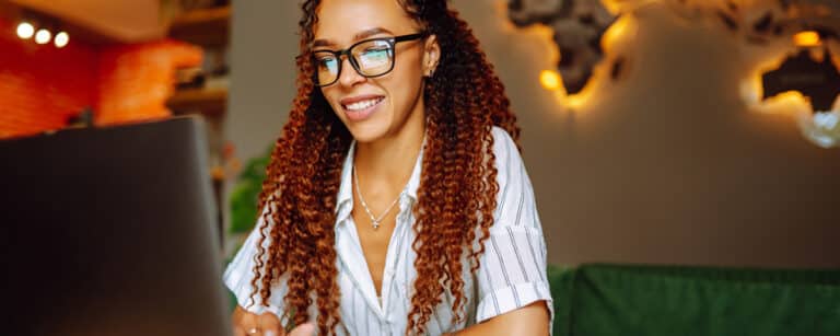 Woman reading news on laptop