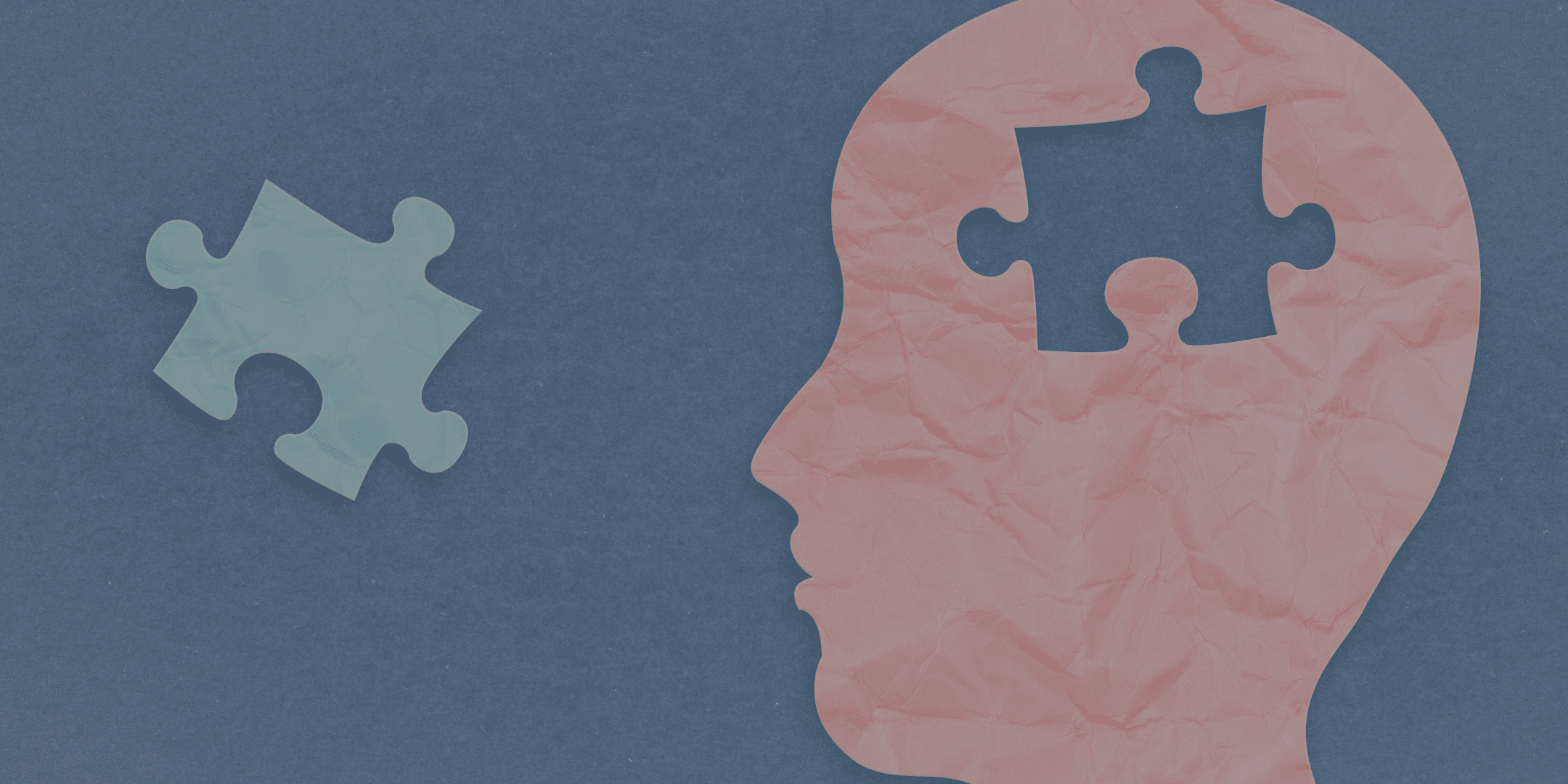 An illustration of a silhouette of a head with a puzzle piece missing, next to the fitting puzzle piece.