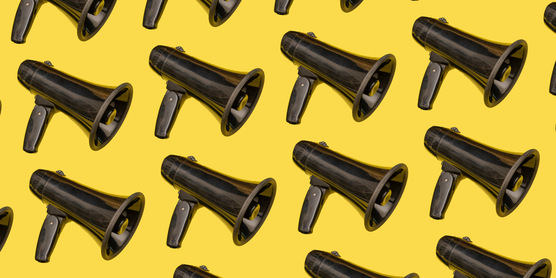 A pattern of black megaphones on a yellow background.